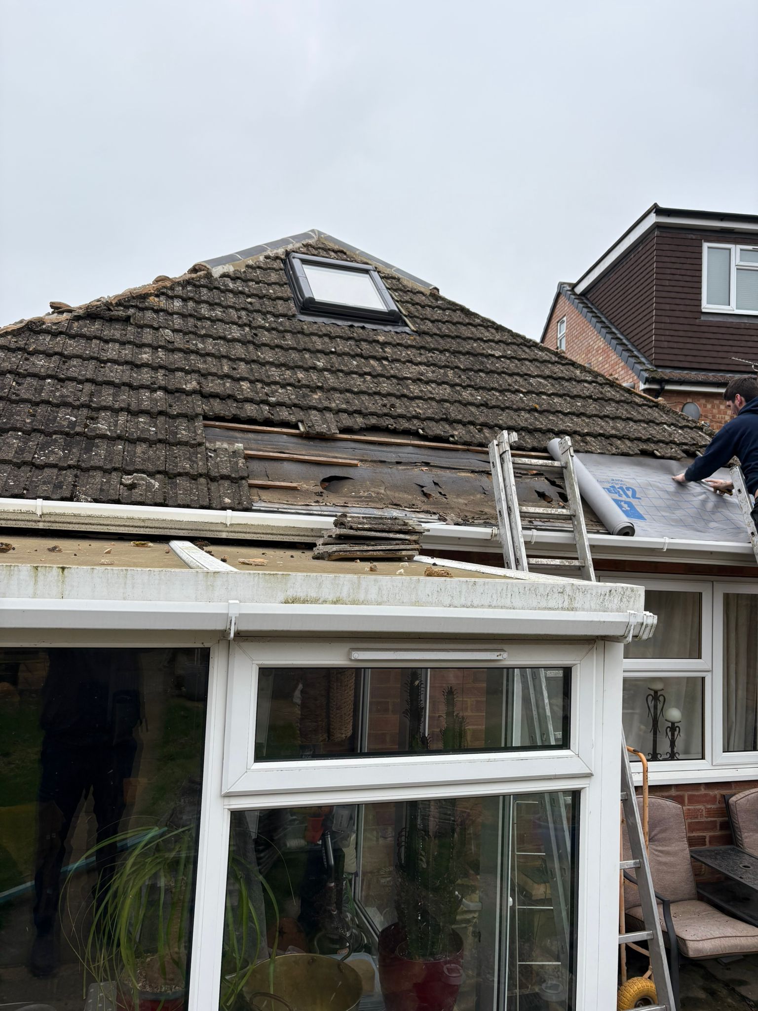 Conservatory roof repair with damaged tiles being replaced