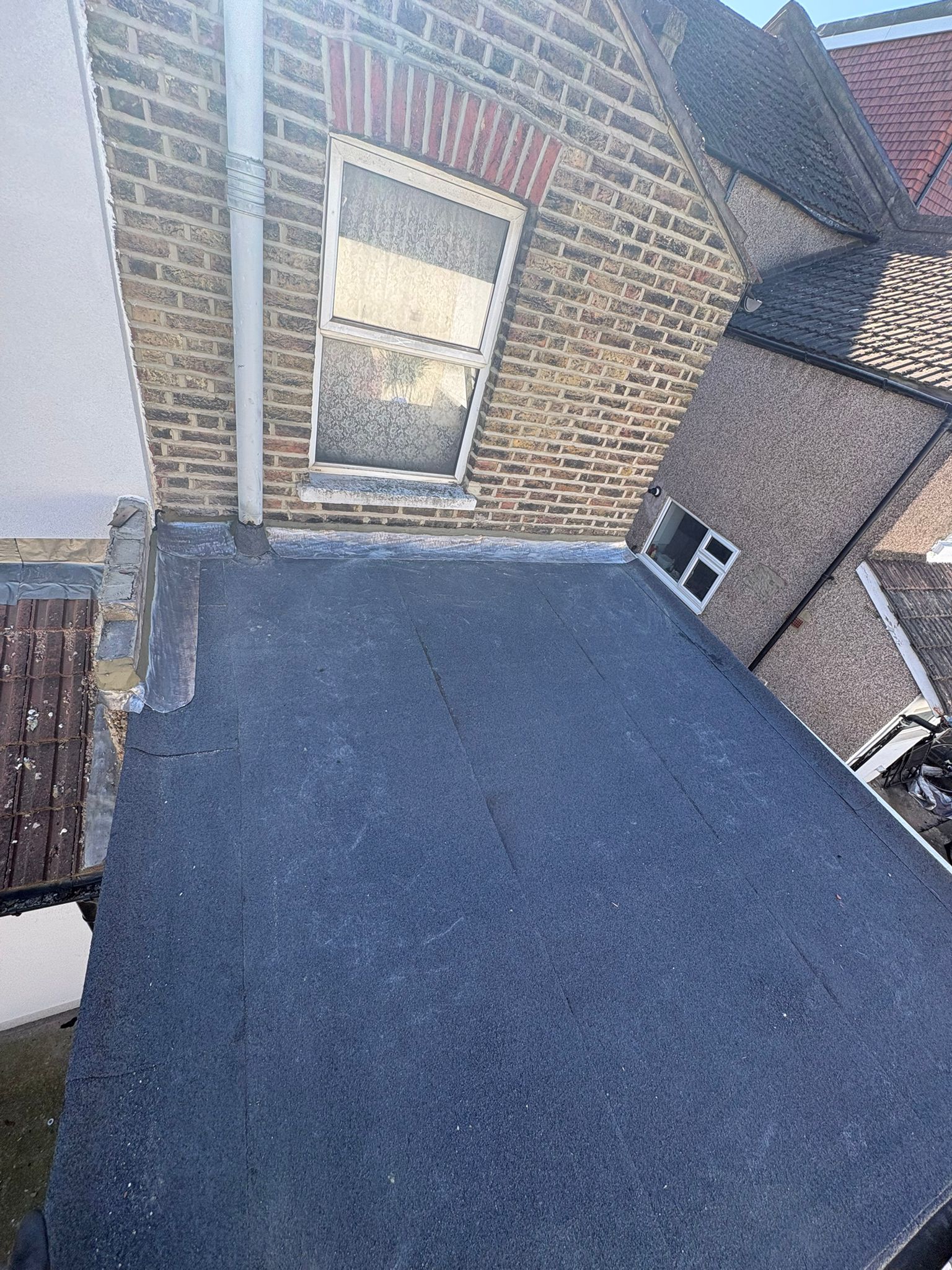 Completed flat roof installation with felt finish